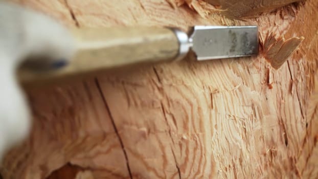 A beautifully detailed closeup of a skilled artisan carefully and precisely carving wood using a sharp chisel. Stock Clip