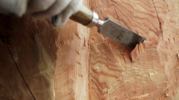A close up view of a chisel meticulously carving intricate and beautiful patterns into fine wood grain. Stock Clip