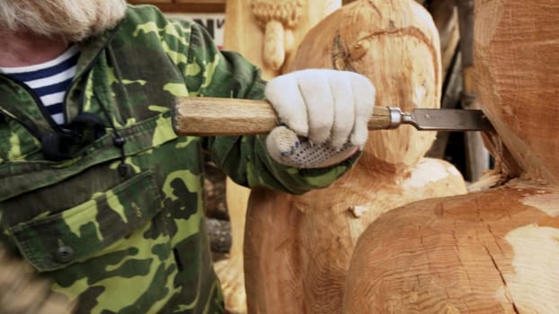 A skilled craftsman meticulously chisels and carves wood, effectively showcasing the beauty of craftsmanship and art. Stock Clip