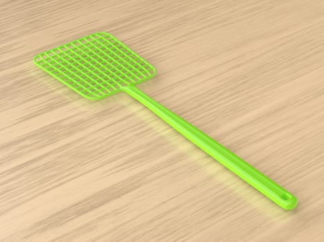 Green fly swatter on a wooden table