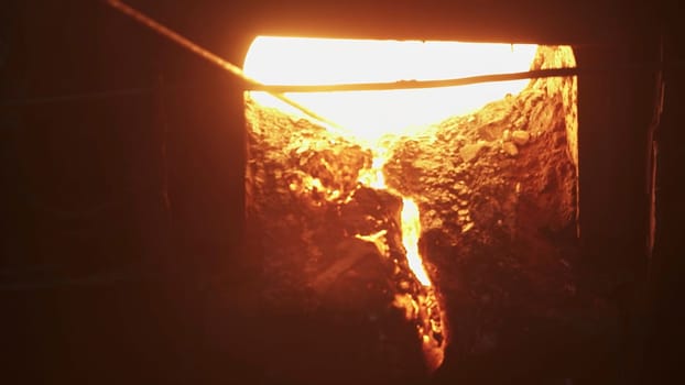 A vivid shot of molten metal flowing from a furnace, showcasing high-temperature industrial processes. Stock Clip