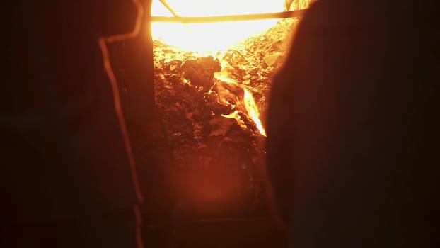 An artisan skillfully working with molten materials in a dimly lit workshop environment filled with creativity. Stock Clip