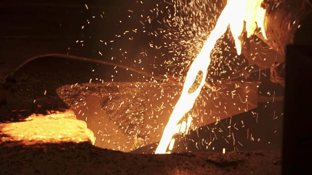 A closeup of molten metal pouring shows the intense heat and dynamic process happening in a foundry. Stock Clip