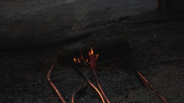 Damaged and exposed wires igniting, vividly showcasing significant fire hazards in dark and dim surroundings. Stock Clip