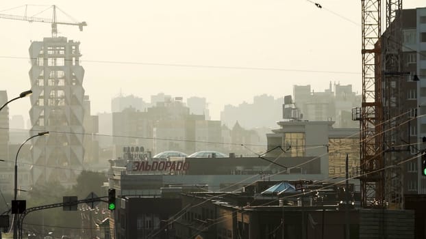 Tbilisi, Georgia - September 29, 2023: An expansive city skyline revealing dynamic construction activity taking place amidst a hazy atmosphere all around. Stock Clip