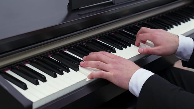 A skilled pianist is performing beautifully on a digital keyboard, showcasing their talent and passion for music. Clip