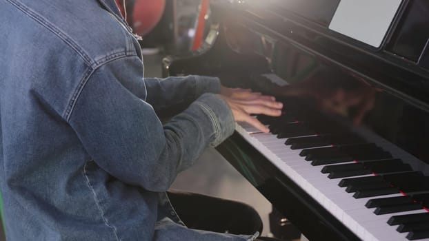 A talented musician plays the piano creatively, showcasing their skill and artistry in a unique environment. Clip