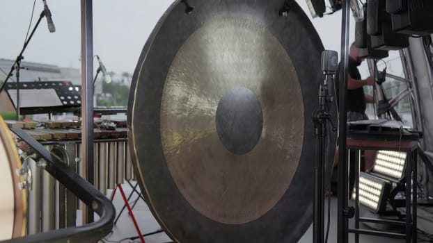 A closeup view of a large, intricate gong ready for an exciting live performance at a memorable event. Clip