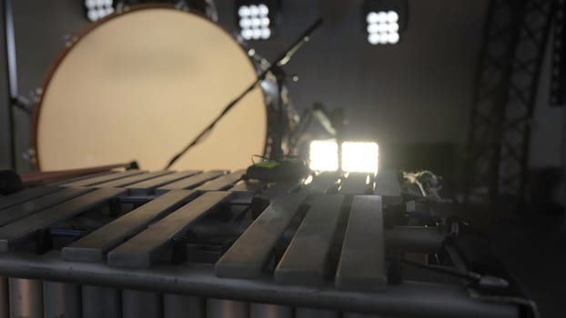 A closeup shot focusing on a beautifully arranged percussion setup that features vibes alongside studio lighting. Clip