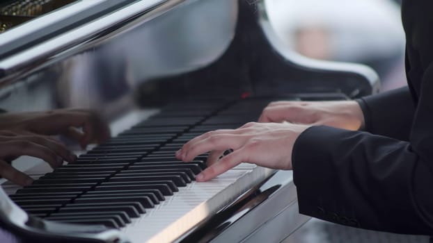 This image showcases a closeup of a hand skillfully playing the piano, highlighting artistry and musicality. Clip