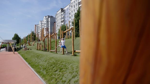 Georgia, Tbilisi - June 17, 2024: An urban park showcasing an array of play structures for children with modern residential buildings in the background. Clip