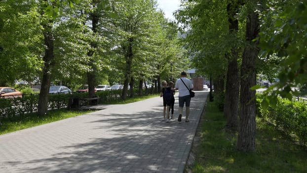 Georgia, Tbilisi - June 17, 2024: A beautifully serene park setting that showcases lush, green trees and a paved walkway for leisurely strolls. Clip