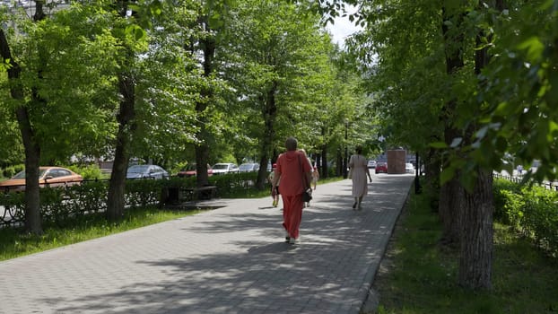 Georgia, Tbilisi - June 17, 2024: A tranquil urban scene featuring lush greenery and a sidewalk view, perfect for nature and city blending. Clip