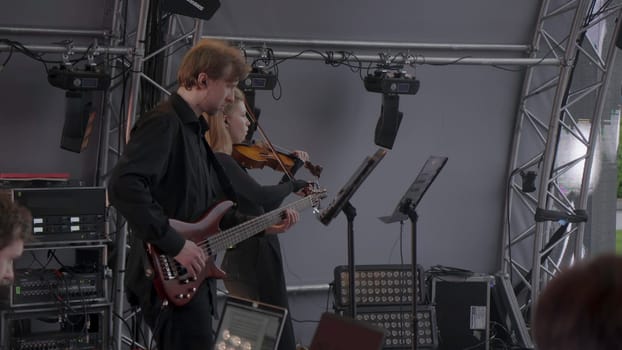 Georgia, Tbilisi - July 20, 2024: An engaging and captivating live music performance showcasing a talented guitarist alongside a skilled violinist. Clip