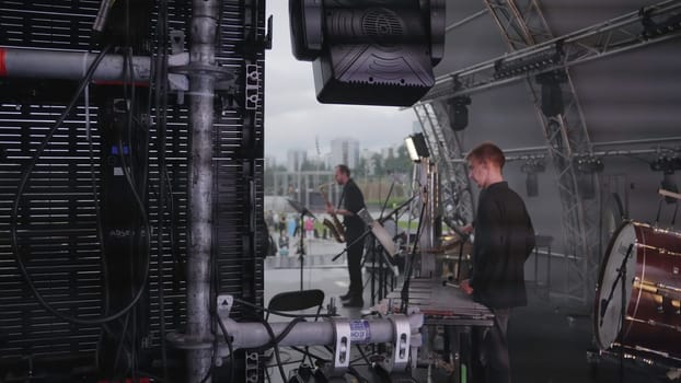 Georgia, Tbilisi - July 20, 2024: A crew member monitors equipment during a live performance setup, emphasizing teamwork and technology. Clip