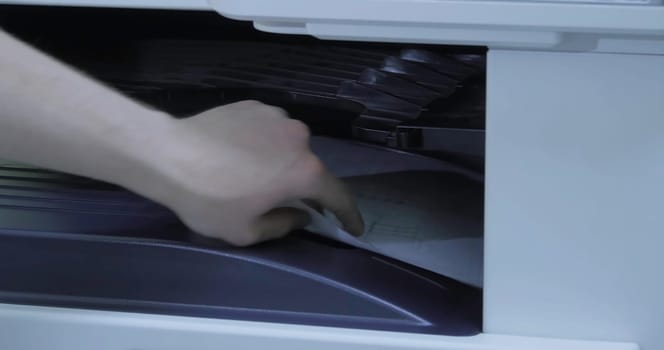 This video shows the printing process in an office, from a printer in action to a person retrieving a document, emphasizing modern efficiency
