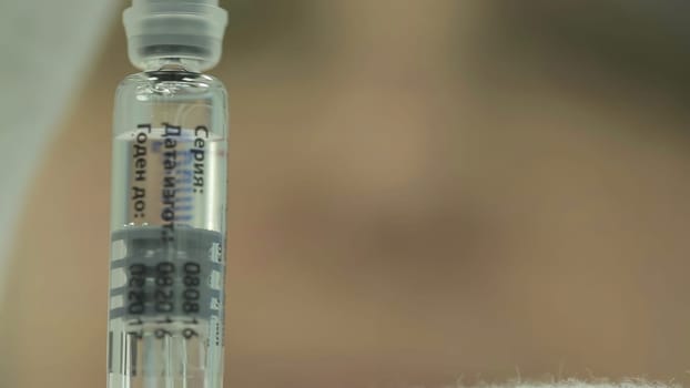 This video highlights vaccinations critical role in public health, showcasing a surgeon, vaccine preparation, and the inoculation moment