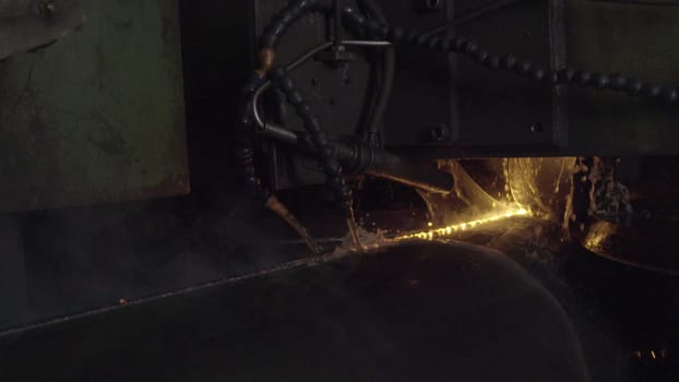 This video showcases metalworking processes, starting with a machine cutting metal, and shifts to a person welding, emphasizing craftsmanship
