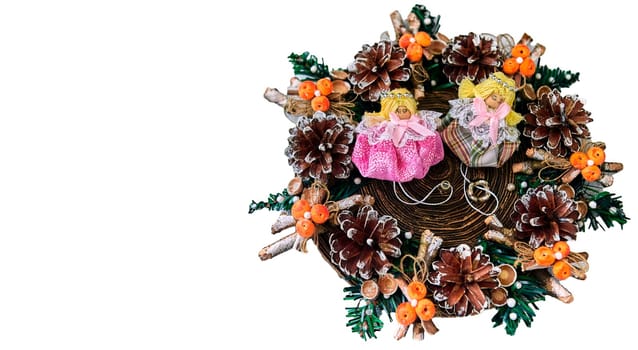 Christmas wreath with pine cones, toys on a white background. With angels in the middle.