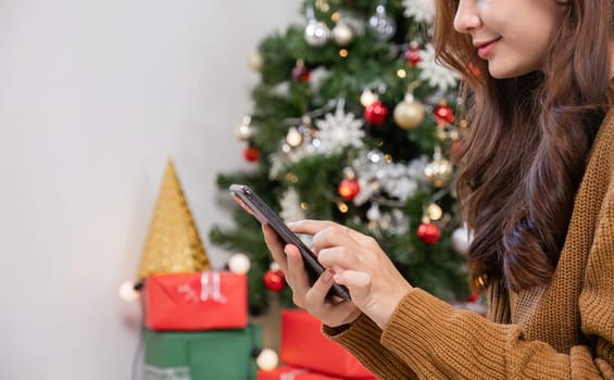 A young woman decorates her room for Christmas, adding festive ornaments and lights to create a cozy holiday atmosphere.
