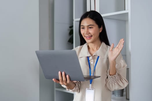 Office workers using online programs for remote collaboration, enhancing productivity in a modern workspace.