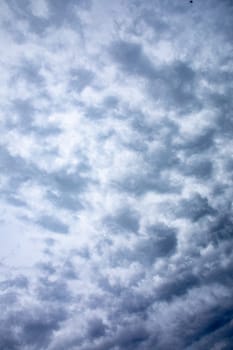 A tranquil and picturesque view of a beautifully cloudy sky showcasing delicate textures and a soothing blue hue