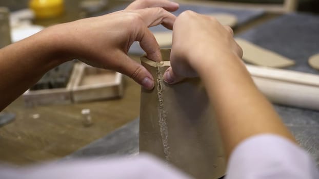 An artisan skillfully shapes clay into stunning pottery, displaying immense creativity and craftsmanship. Stock Clip