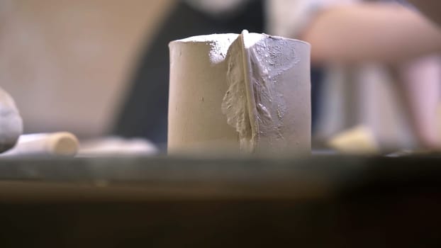 A close up of skilled hands expertly shaping and crafting clay pottery in a beautifully artistic studio setting. Stock Clip