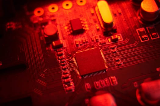 A visually striking macro shot featuring a detailed circuit board illuminated with vibrant red hues and tones