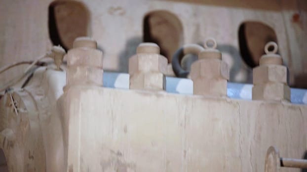 An intricate and detailed closeup view of various mechanical components displaying significant dust accumulation. Stock Clip
