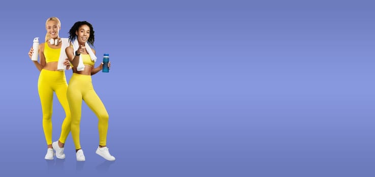 Two women dressed in bright yellow workout outfits stand confidently with water bottles. They are smiling, embodying a healthy and active lifestyle after exercising.