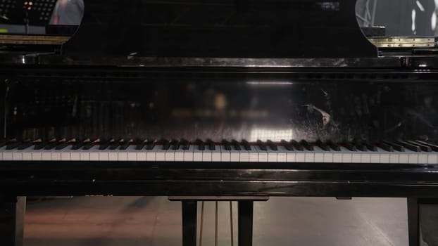 An elegant black grand piano, beautifully designed, the perfect centerpiece for musical performances. Clip