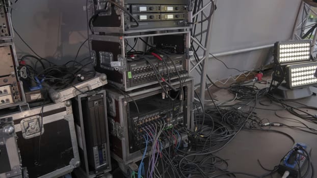 The image showcases a media setup with various equipment and tangled cables, ideal for professional events. Clip