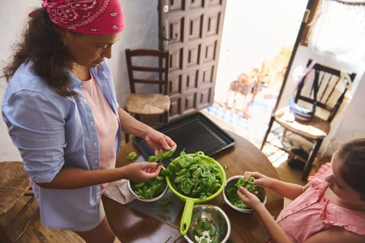 A mother and daughter enjoy a bonding moment while preparing a fresh salad together in a cozy, rustic kitchen. The warm atmosphere emphasizes family, connection, and healthy living.
