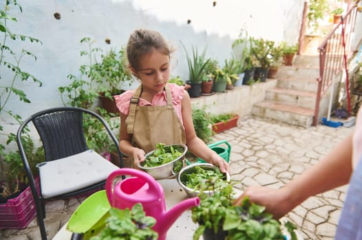 A young girl wearing an apron tends to her garden in a cozy backyard, holding bowls of fresh greens. The setting is lush and green, highlighting the joys of gardening and outdoor activities.