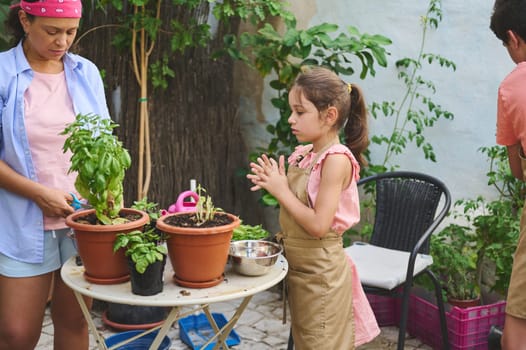 A family enjoys gardening together, nurturing potted plants on a sunny day. The scene highlights teamwork, nature, and joyful outdoor activity, fostering environmental awareness and learning.