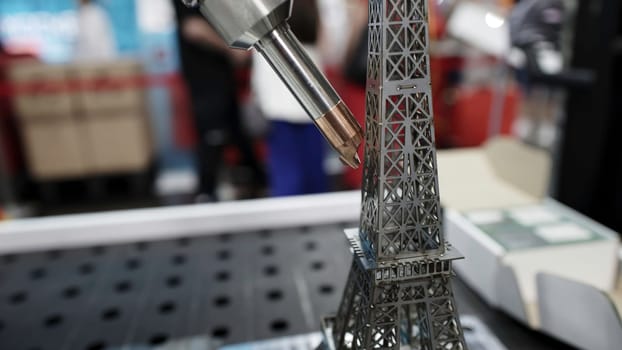 An intricately detailed shot of a meticulously crafted miniature Eiffel Tower made with advanced precision tools. Media