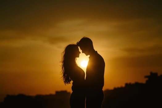 A couple standing in a beaut beach, holding each other close as the golden sun sets in the background., silhouette , valentine concept --ar 3:2 --style raw --v 6.1 Job ID: 1bb7396b-d6db-4fe3-8291-1703126b7e00