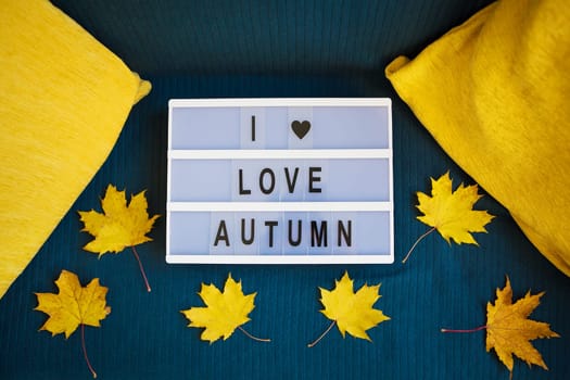 lightbox with yellow leaves on a plaid-inscription I love autumn.