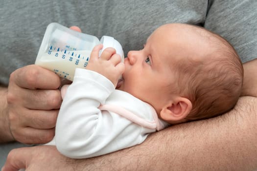 Witness the profound love of a man for his newborn as he provides nourishing formula milk