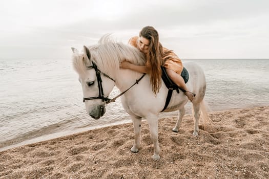 A white horse and a woman in a dress stand on a beach, with the sky and sea creating a picturesque backdrop for the scene