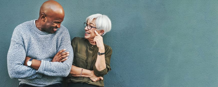 Business people, conversation and staff on wall background, planning and funny with mockup space. Black man, woman and workers with happiness, discussion and brainstorming with humor, joke and ideas.