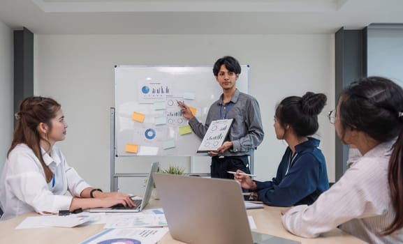 Male employee presenting work at a meeting Statistics collected from the business of a company or organization. Executives and members of the organization know.