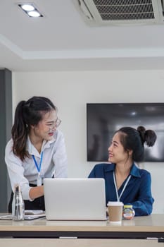 team business people talk project strategy at office meeting room. Businesswoman discuss project planning with colleague at modern workplace while having conversation and advice on financial report.