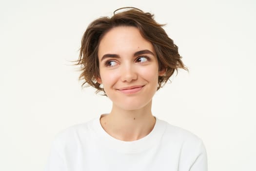 Close up portrait of brunette woman laughing and smiling, express genuine emotions, posing against white studio background.