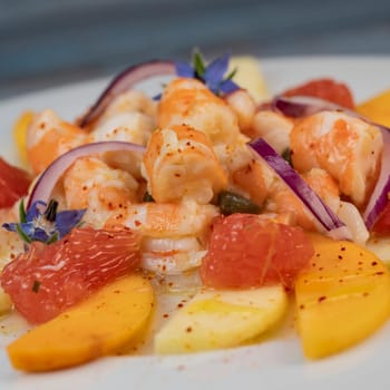 RECIPE CEVICHE OF SHRIMPS AND SCALLOPS WITH CITRUS FRUIT, LEMON, LIME, SQUEEZED ORANGE, GRAPEFRUIT AND FRUIT, PERSIMMON, APPLE, SEASONED WITH ESPELETTE PEPPER. High quality photo