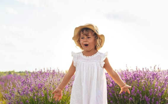 Child girl in lavender field. Selective focus. Kid.