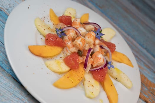 RECIPE CEVICHE OF SHRIMPS AND SCALLOPS WITH CITRUS FRUIT, LEMON, LIME, SQUEEZED ORANGE, GRAPEFRUIT AND FRUIT, PERSIMMON, APPLE, SEASONED WITH ESPELETTE PEPPER. High quality photo