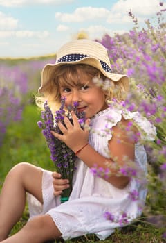 Child girl in lavender field. Selective focus. Kid.