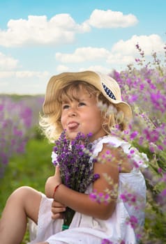 Child girl in lavender field. Selective focus. Kid.